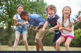 stock-photo-children-playing-tug-of-war-at-the-park-459100483