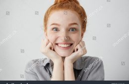 stock-photo-tell-me-more-close-up-shot-of-curious-y-o-redhead-caucasian-woman-pillowing-face-on-her-hands-644584180